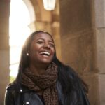 Portrait of an African American black woman laughing outdoors.